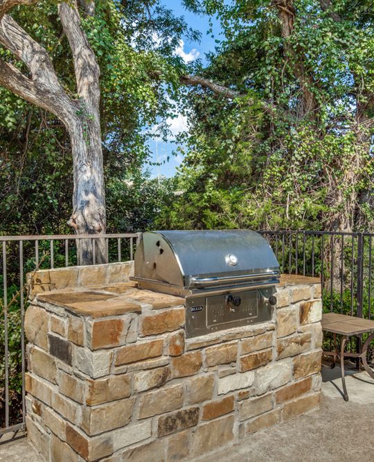 Picture of an outdoor grill with rock surround