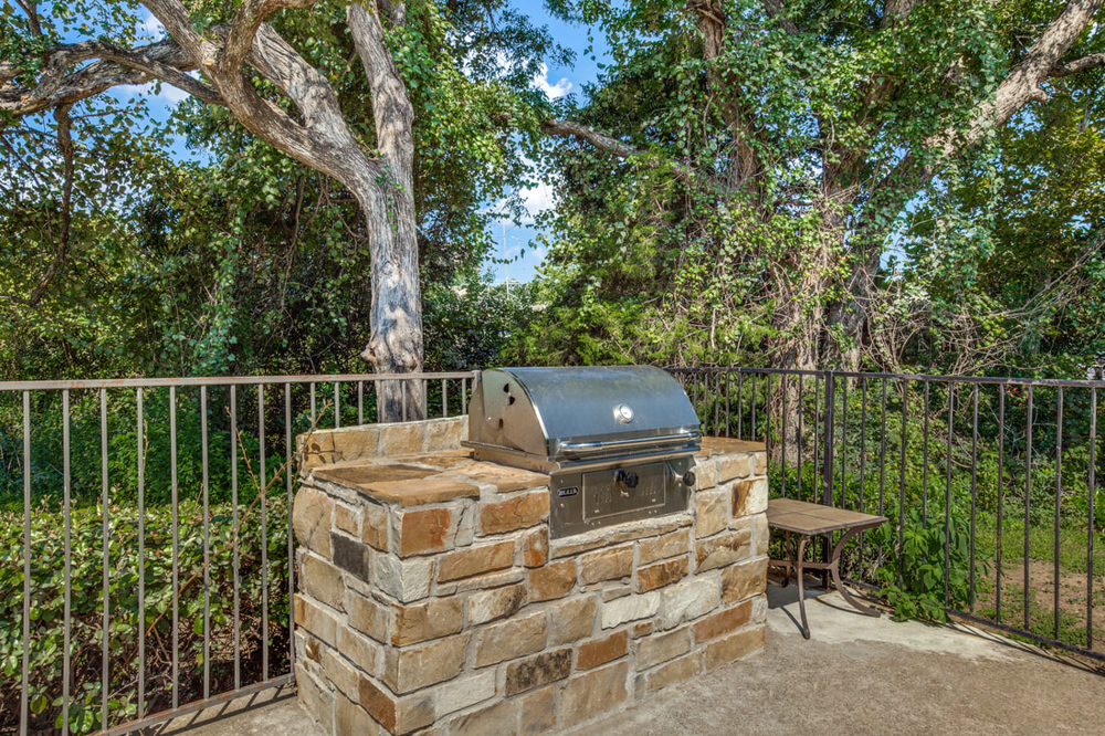 Picture of an outdoor grill with rock surround