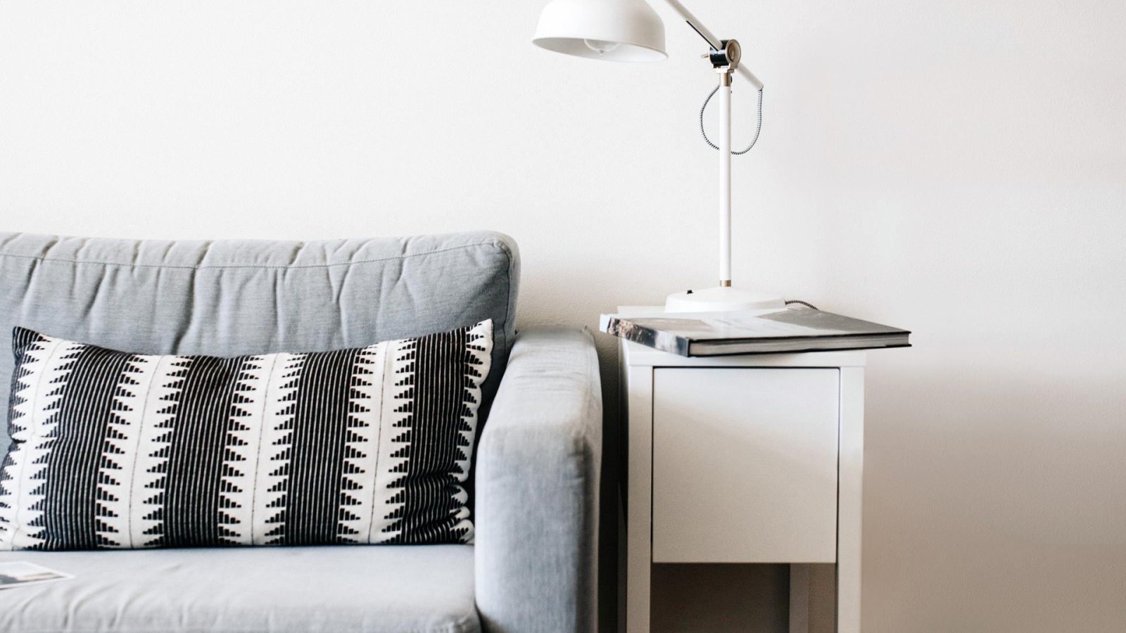 denim couch with end table and lamp